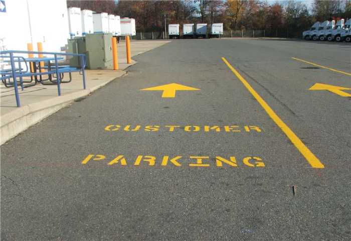 We Do Lines - A parking lot with arrows pointing to customer parking.