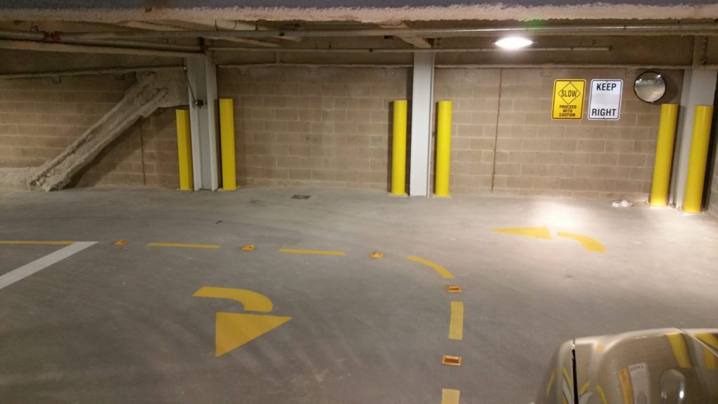 We Do Lines - A car is parked in a parking garage.