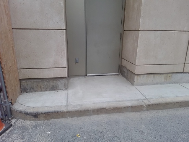 We Do Lines - A doorway with a concrete floor next to it.