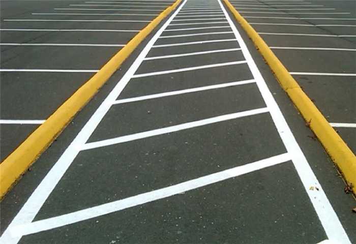 We Do Lines - A parking lot with white lines painted on it.