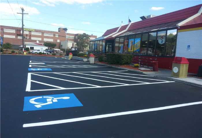 We Do Lines - A parking lot with a handicap parking space.