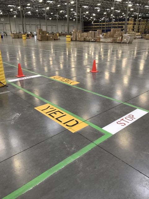 We Do Lines - A warehouse with green cones on the floor.