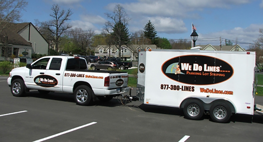 We Do Lines - A truck parked in a parking lot with a sign on it containing information about us.