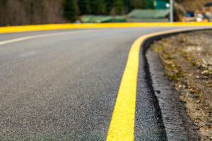 We Do Lines - A yellow line on the side of a road.