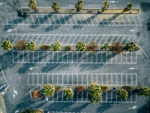 We Do Lines - An aerial view of a parking lot with palm trees.