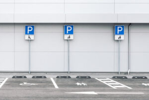 We Do Lines - A row of parking signs in front of a building.