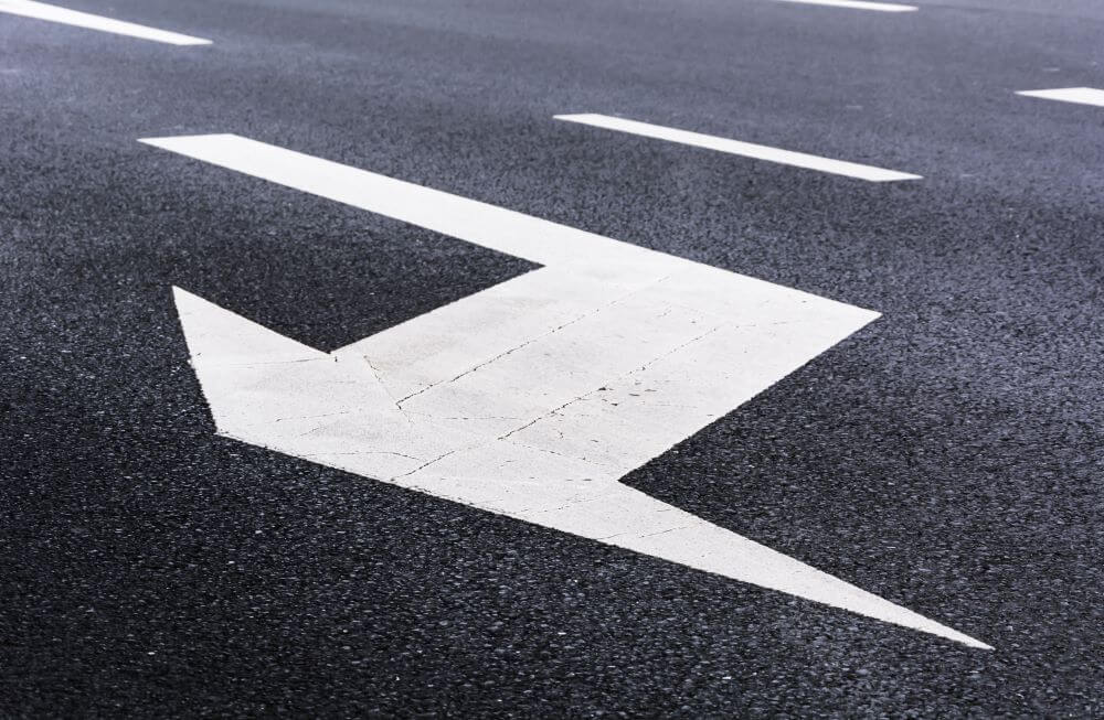 photo of a road with an arrow indicating a lane change