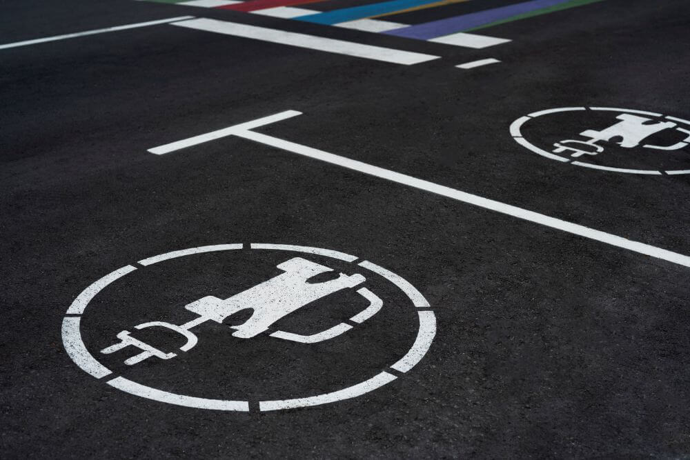 Carpark with two electric car charging spot signs on the tarmac