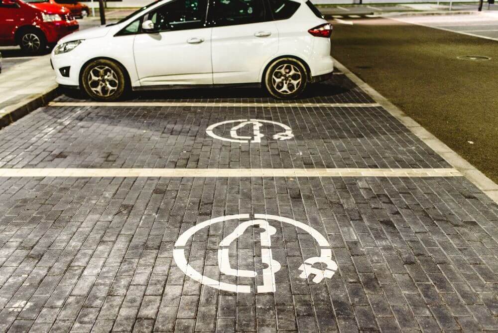 car park with two electric car charging spot signs